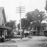 black and white town with trolley car